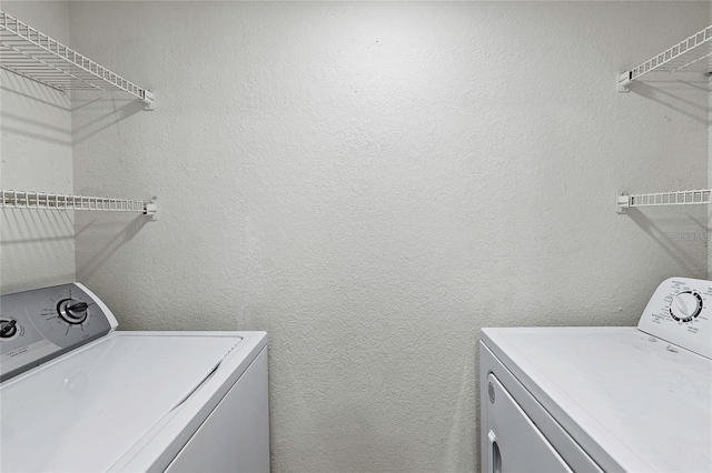 laundry room featuring washing machine and clothes dryer