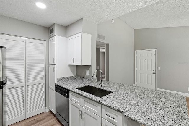 kitchen with sink, light stone countertops, a textured ceiling, stainless steel dishwasher, and white cabinets