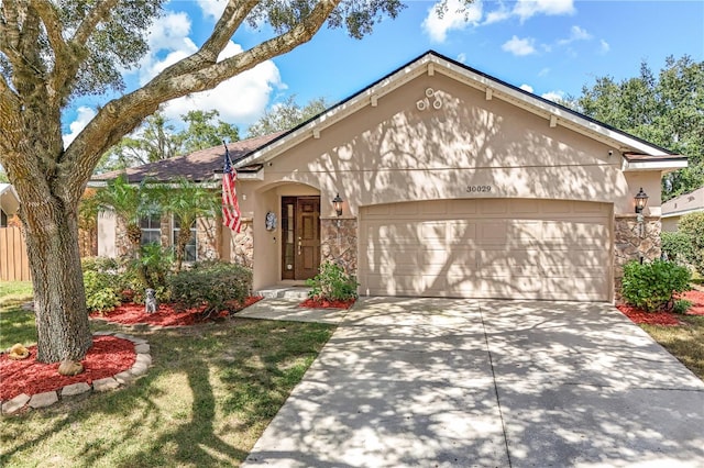 view of front of property featuring a front lawn and a garage