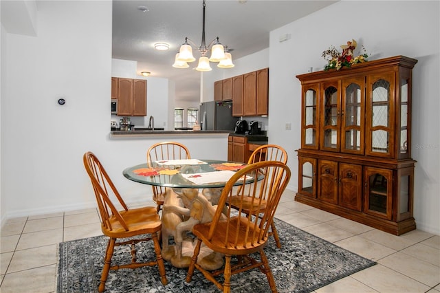 dining room featuring light tile patterned floors and a notable chandelier