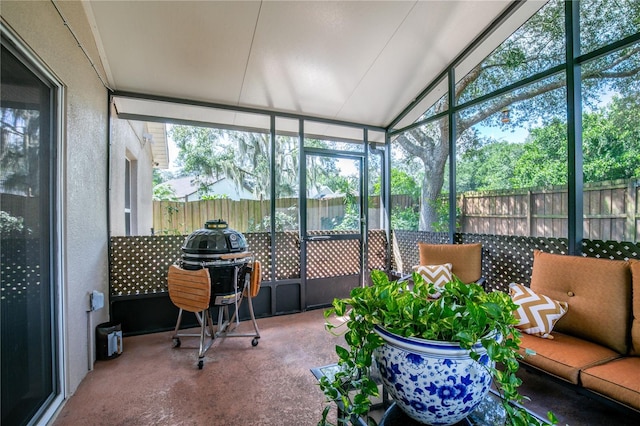 sunroom featuring lofted ceiling