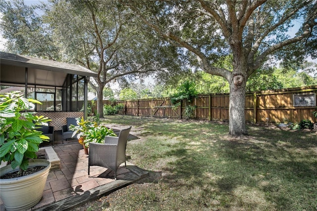 view of yard featuring a patio and a sunroom