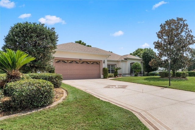 view of front of property featuring a garage and a front yard