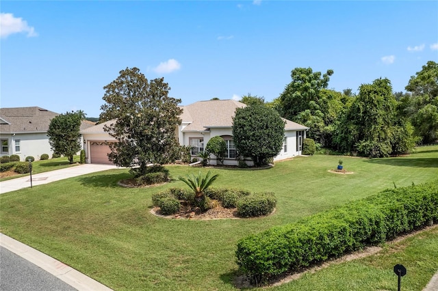 view of front of property featuring a garage and a front lawn