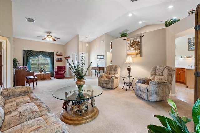 carpeted living room featuring ceiling fan and vaulted ceiling