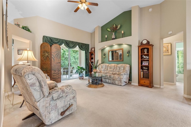 living room with ceiling fan, light colored carpet, and high vaulted ceiling