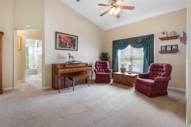 sitting room with ceiling fan, light colored carpet, and high vaulted ceiling