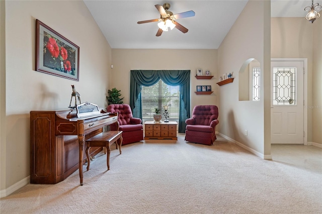 living area featuring light carpet and ceiling fan