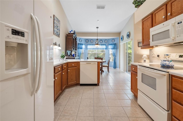 kitchen with white appliances, kitchen peninsula, light tile patterned floors, pendant lighting, and lofted ceiling