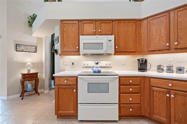 kitchen featuring white appliances and light tile patterned floors