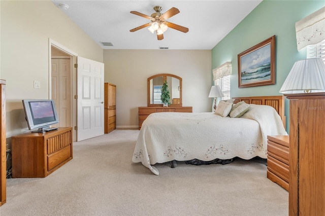 bedroom with light carpet, multiple windows, and ceiling fan