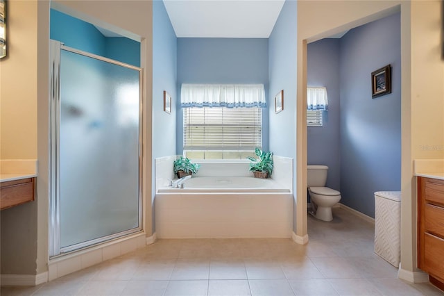 full bathroom with vanity, toilet, plus walk in shower, and tile patterned floors