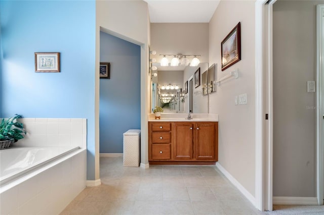 bathroom featuring vanity, tiled bath, and tile patterned flooring