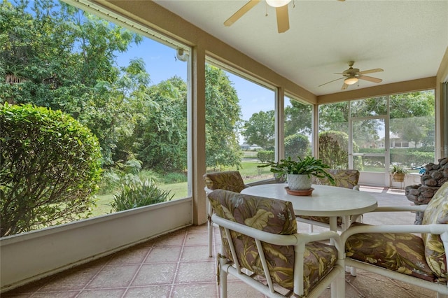 sunroom featuring ceiling fan and a healthy amount of sunlight