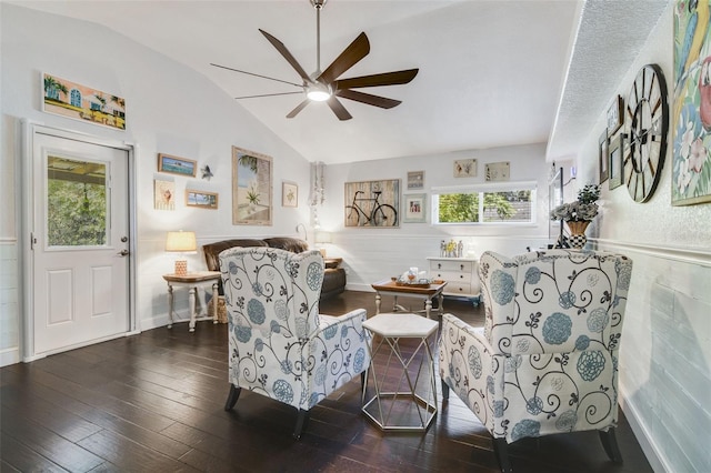 living room featuring ceiling fan, dark wood-type flooring, a healthy amount of sunlight, and vaulted ceiling