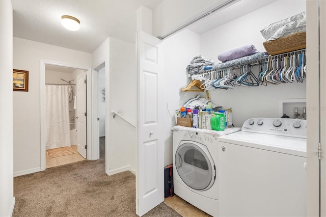 clothes washing area featuring washing machine and dryer and light colored carpet