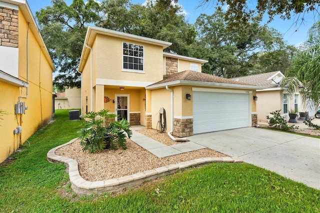 view of front of home featuring a garage, cooling unit, and a front lawn