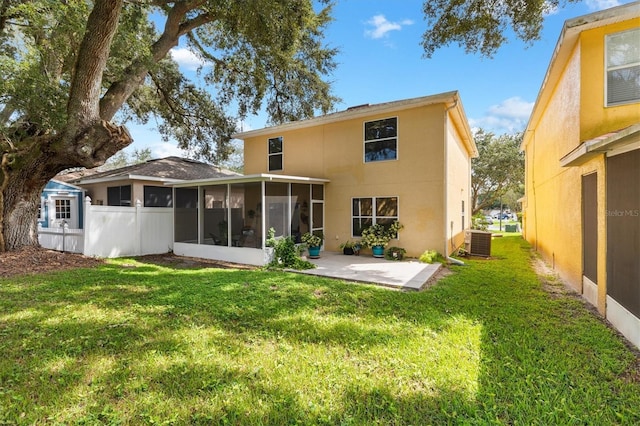 rear view of property with a patio, central AC, a yard, and a sunroom