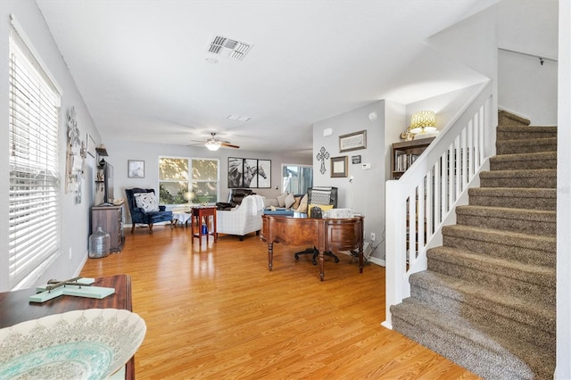 living room featuring hardwood / wood-style flooring and ceiling fan