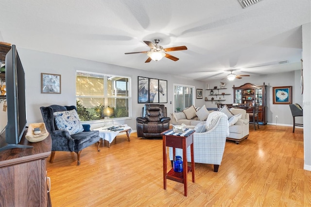 living room with light wood-type flooring and ceiling fan