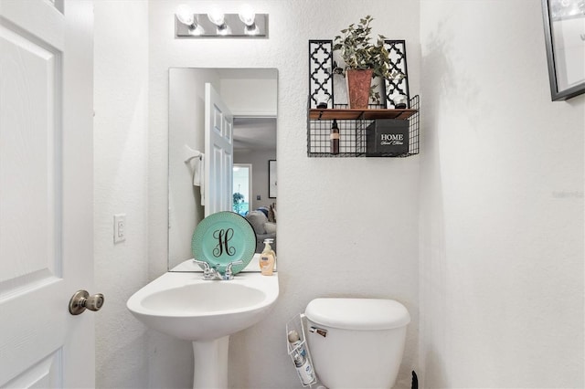 bathroom featuring sink and toilet