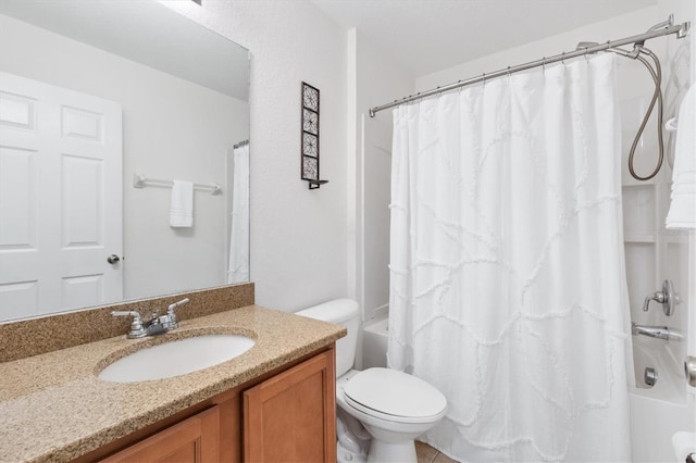 full bathroom with vanity, shower / bath combo, and toilet