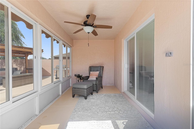 sunroom featuring ceiling fan