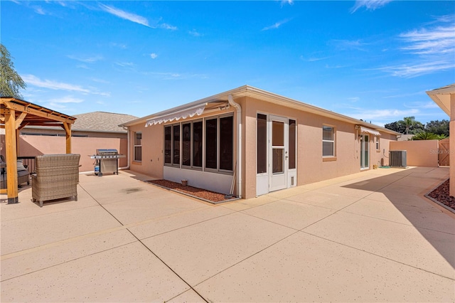 rear view of property featuring central air condition unit and a patio area