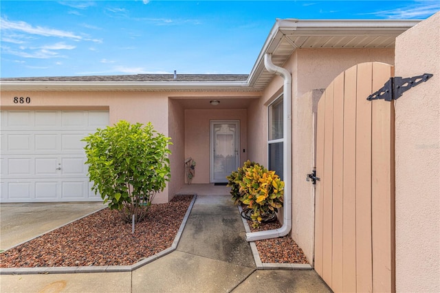 doorway to property with a garage