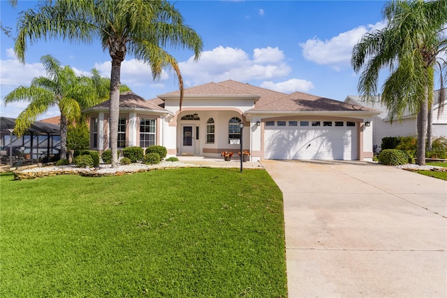 mediterranean / spanish-style house featuring a front yard and a garage