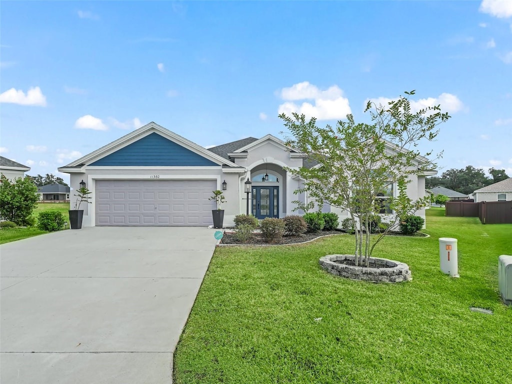 single story home with a front yard and a garage