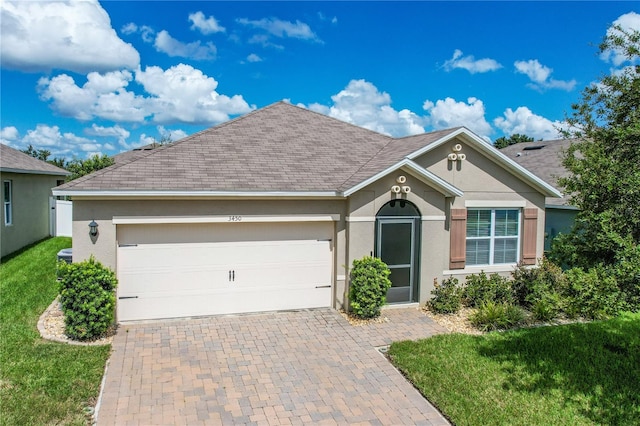 view of front of house featuring a garage and a front lawn