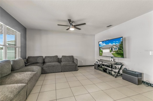 tiled living room featuring a textured ceiling and ceiling fan