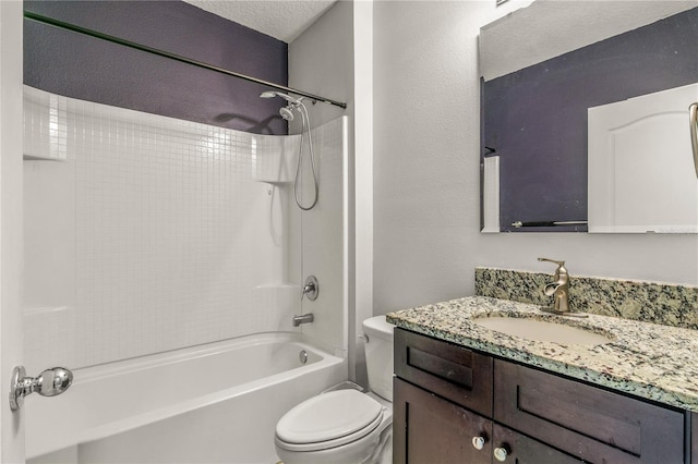 full bathroom with vanity, a textured ceiling, washtub / shower combination, and toilet