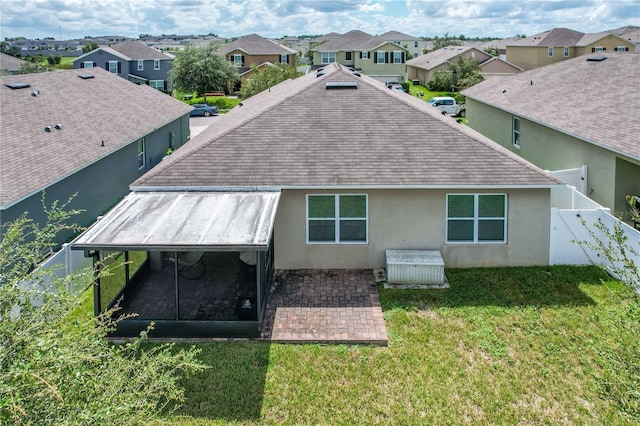 back of house featuring a lawn and a patio area