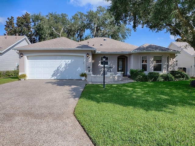 single story home featuring a front yard and a garage