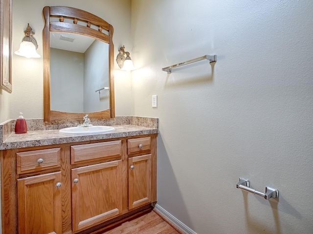 bathroom with hardwood / wood-style flooring and vanity