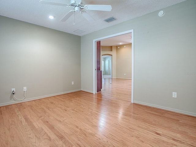 unfurnished room featuring ceiling fan, a textured ceiling, and light hardwood / wood-style flooring