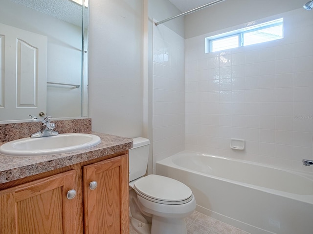 full bathroom featuring vanity, tiled shower / bath combo, and toilet