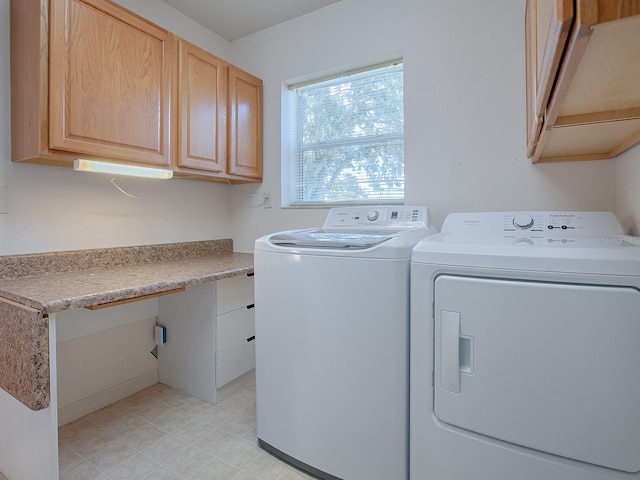 laundry area featuring separate washer and dryer and cabinets