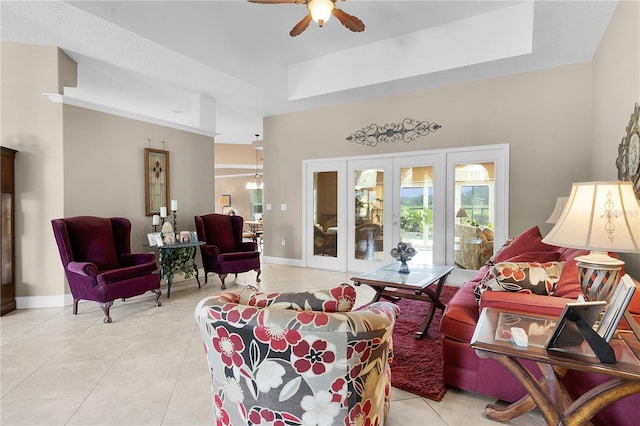 tiled living room with ceiling fan and french doors