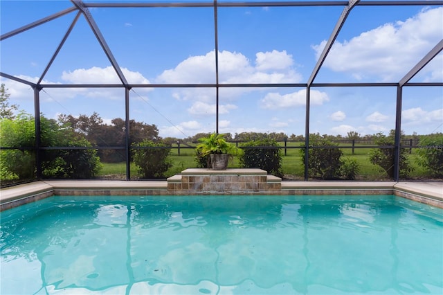 view of swimming pool with a lanai