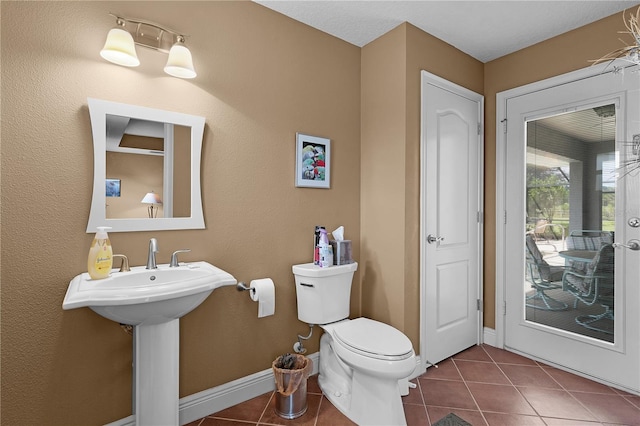 bathroom featuring sink, toilet, and tile patterned floors