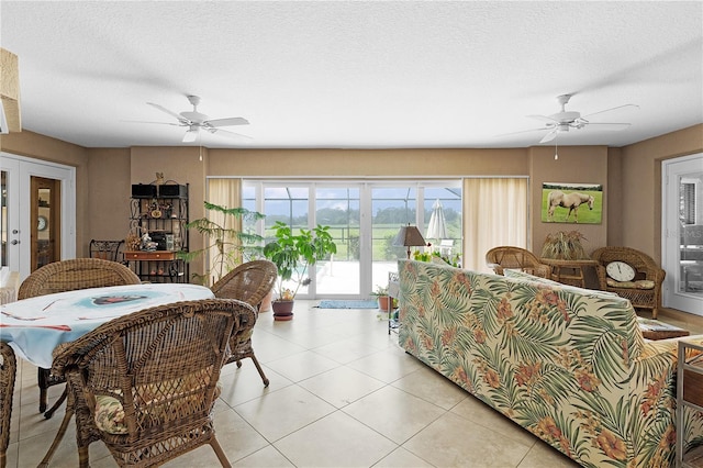 dining room featuring ceiling fan, a textured ceiling, and light tile patterned flooring