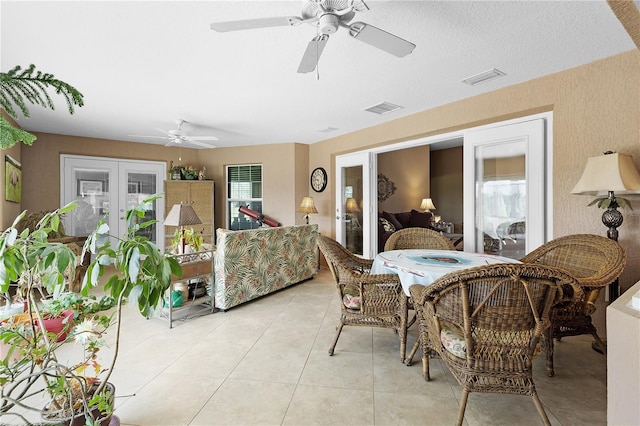 dining space featuring light tile patterned floors, ceiling fan, french doors, and plenty of natural light