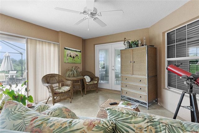 living room with ceiling fan and a textured ceiling