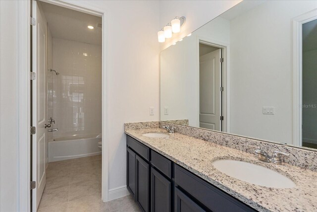 full bathroom with vanity, tile patterned floors, tiled shower / bath, and toilet