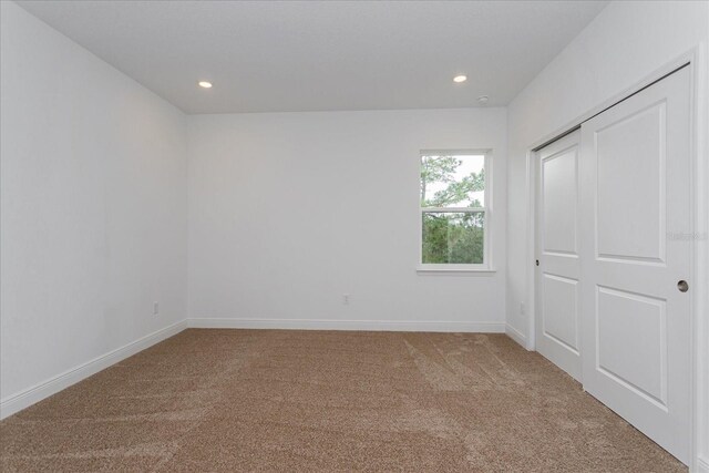 unfurnished bedroom with a closet and carpet flooring