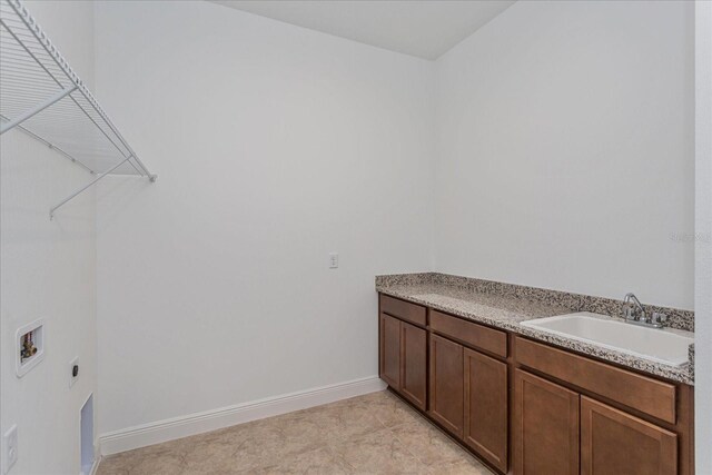 washroom with electric dryer hookup, hookup for a washing machine, light tile patterned flooring, and sink