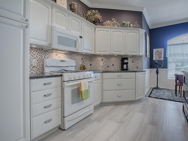 kitchen featuring crown molding, white cabinets, and white appliances